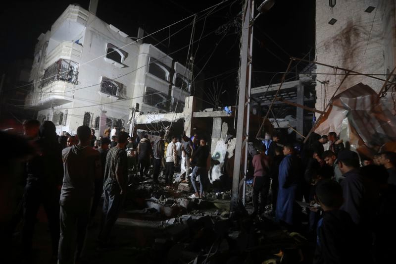 Palestinians inspect the rubble of destroyed buildings of the Abo al Hanood family after an Israeli airstrike in Rafah refugee camp, southern Gaza Strip, Wednesday, April 17, 2024. Palestinian medics said several residents, including children, were killed in the airstrike. (AP Photo/Ismael Abu Dayyah)