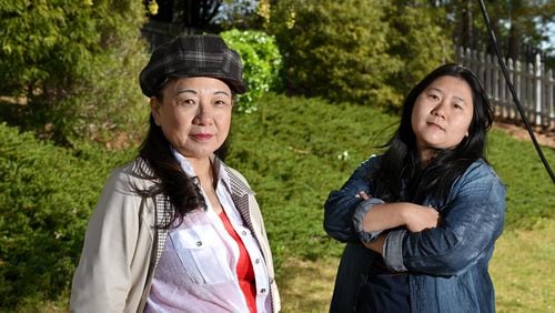Jing Zheng (left) and Jing Su at Su's home in Suwanee on Thursday, April 1, 2021. They are friends and Chinese American immigrants who have joined recent vigils and rallies in the wake of the March 16 spa shootings, the first time for either of them.  (Hyosub Shin / Hyosub.Shin@ajc.com)