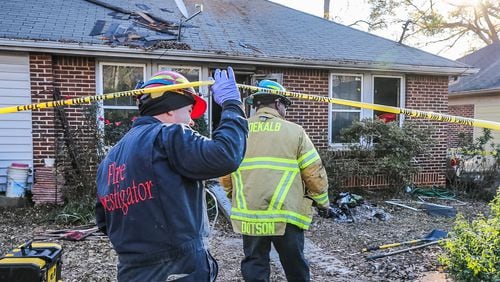 A woman died after crews rescued her from a house fire Friday near Decatur. JOHN SPINK / JSPINK@AJC.COM