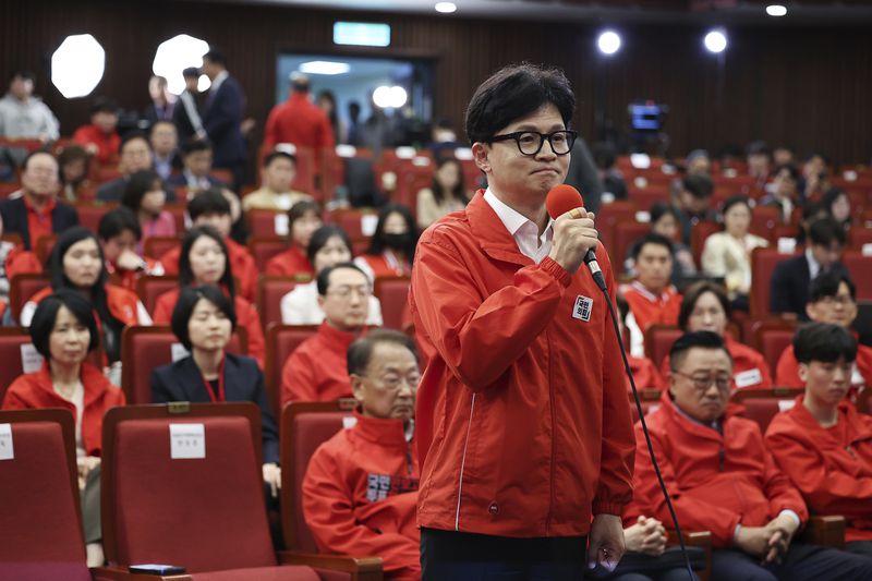 The ruling People Power Party's leader Han Dong-hoon, front, and party members watch TV broadcasting results of exit polls for the parliamentary election at the National Assembly on Wednesday, April 10, 2024 in Seoul, South Korea. (Kim Hong-Ji/Pool Photo via AP)