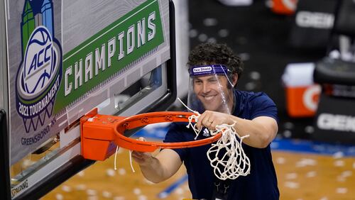 Georgia Tech head coach Josh Pastner cuts the net as he celebrates his teams 80-75 win over Florida State in the basketball Championship game of the Atlantic Coast Conference tournament in Greensboro, N.C., Saturday, March 13, 2021. (AP Photo/Gerry Broome)