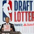 NBA Deputy Commissioner Mark Tatum announces that the Atlanta Hawks won the third pick during the NBA basketball draft lottery Tuesday, May 15, 2018, in Chicago.