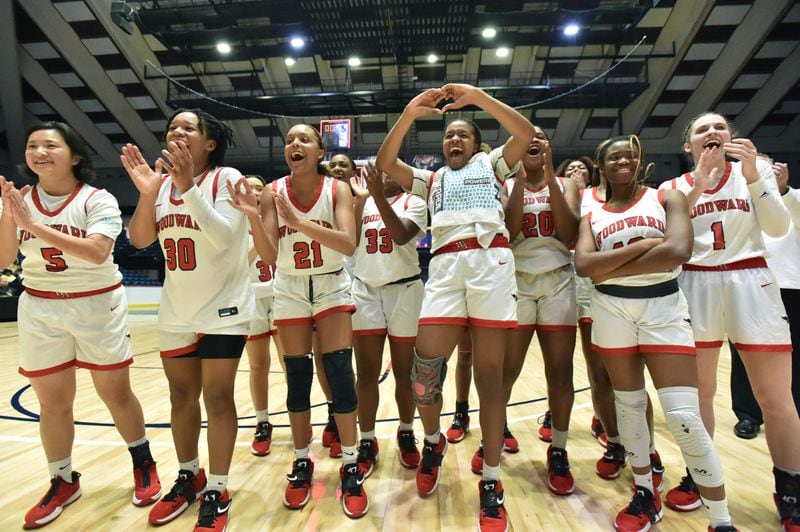 March 10, 2022 Macon - Woodward Academy players celebrate their victory over Forest Park during the 2022 GHSA State Basketball Class AAAAA Girls Championship game at the Macon Centreplex in Macon on Thursday, March 10, 2022. (Hyosub Shin / Hyosub.Shin@ajc.com)