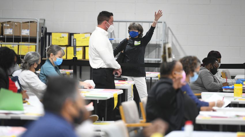 An observer taklks to an official as votes for President are recounted at the Gwinnett County elections office on Friday, Nov.13, 2020 in Lawrenceville. (JOHN AMIS FOR THE ATLANTA JOURNAL-CONSTITUTION)