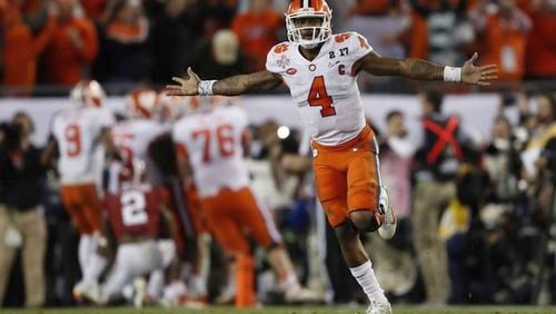 Clemson's Deshaun Watson celebrates a last second touchdown pass to Hunter Renfrow in the second half of the NCAA college football playoff championship game against Alabama in Tampa, Fla.