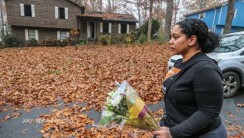 Brandace Colbert brought flowers Wednesday to the scene of a deadly house fire in Cobb County.
