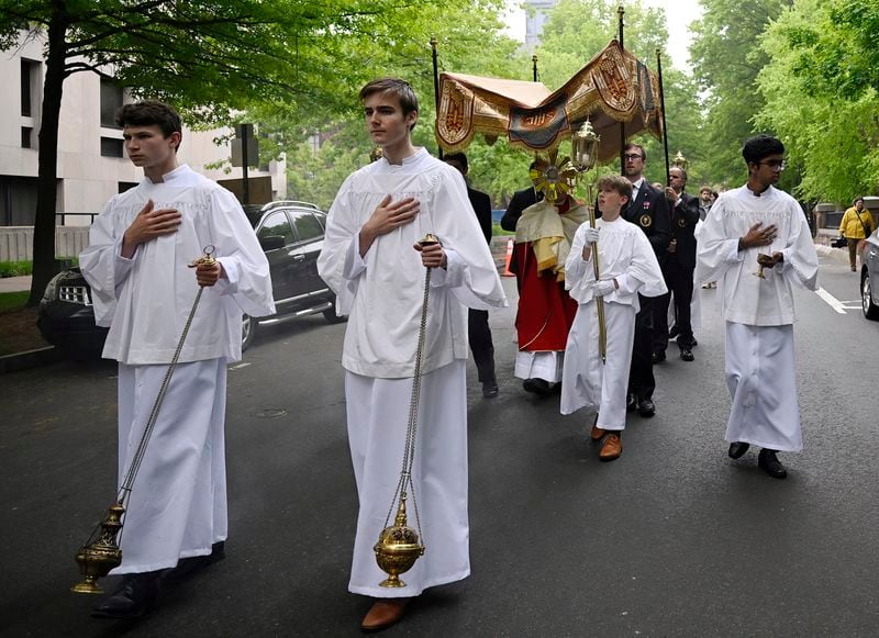 The Eucharistic host is held in a monstrance during a procession outside of St. Mary's Church, Saturday, May 18, 2024, in New Haven, Conn. The Eucharistic Procession from St. Mary's Church is one of four pilgrimage routes crossing the country and converging at the National Eucharistic Congress in Indianapolis, July 16. (AP Photo/Jessica Hill)