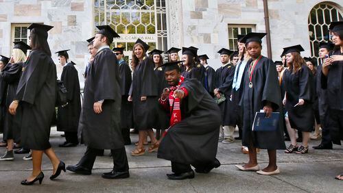 During the Processional, graduates display a variety of emotions and actions. U.S. Rep. and Civil Rights leader John Lewis was the keynote speaker at Emory University's 2014 spring commencement, Emory's 169th. 15,000 people were expected to attend. BOB ANDRES / BANDRES@AJC.COM