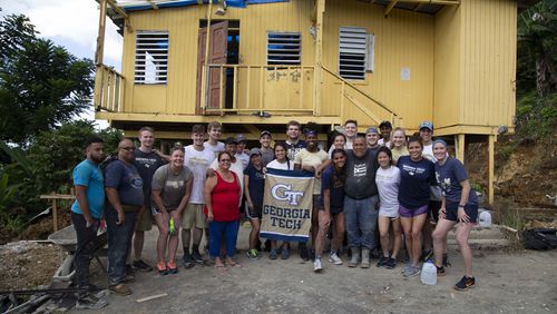 Georgia Tech athletes pose in front of a home in Vega Alta, Puerto Rico, as part of their service trip in May 2018. The team cut out the foundation from under the home, which was to be torn down, and poured in a new one. (Brad Malone/Georgia Tech Athletics)