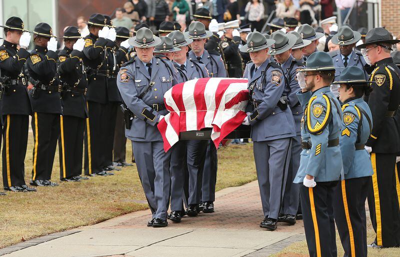 December 14, 2016, AMERICUS: The honor guard salutes the escort passing by with Georgia Southwestern State University campus police officer Jody Smith at the conclusion of his funeral service at the university on Wednesday, Dec. 14, 2016, in Americus. Officer Smith and Americus police officer Nicholas Ryan Smarr, best friends, were killed responding to a domestic dispute.     Curtis Compton/ccompton@ajc.com