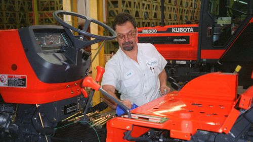 Kubota said it has begun production at its newest plant in Gainesville. In this undated photo, Kubota employee Greg Smith oversees production of a Kubota tractor in Georgia. (AJC Staff Photo/Peter Kent)