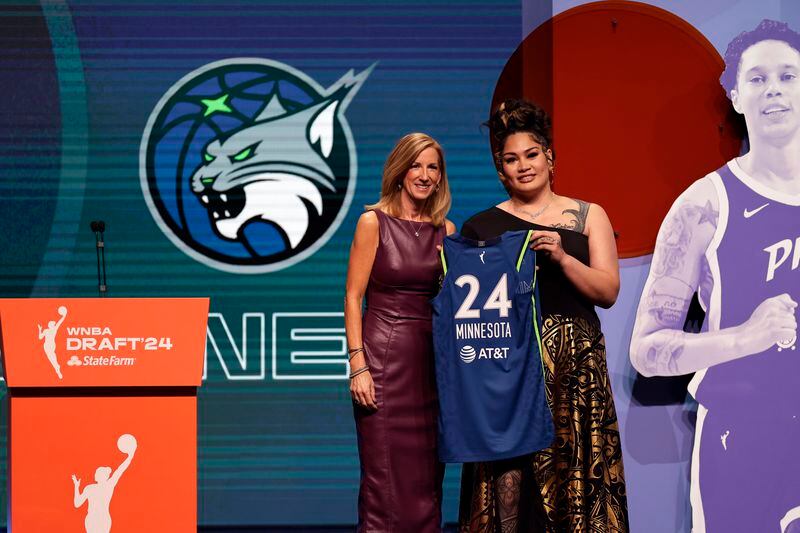Utah's Alissa Pili, right, poses for a photo with WNBA commissioner Cathy Engelbert after being selected eighth overall by the Minnesota Lynx during the first round of the WNBA basketball draft on Monday, April 15, 2024, in New York. (AP Photo/Adam Hunger)