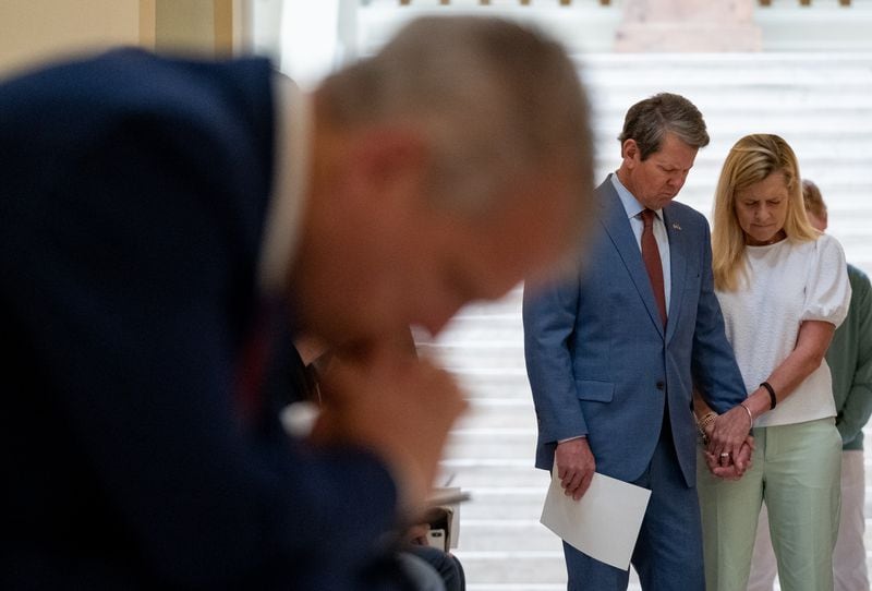 Gov. Brian Kemp and his wife, Marty, pray during a prayer service called by Kemp on Monday morning, April 27, 2020, at the state Capitol. (credit: Ben@BenGray.com for the Atlanta Journal-Constitution)