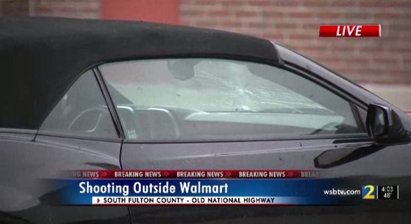 At least two bullets struck the windshield of a car parked in front of the store.