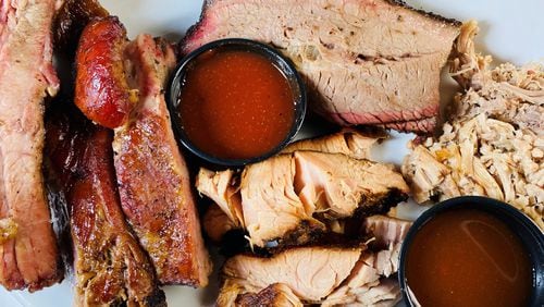 The Pitmaster Platter at Ford’s BBQ includes pulled pork, brisket, turkey, sausage, ribs and a choice of four sides. 
Bob Townsend for the Atlanta Journal-Constitution.