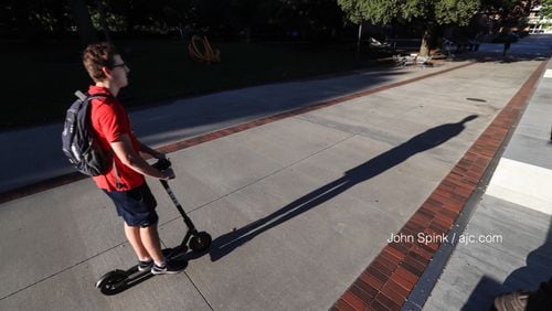 Jack Hearn, 20, a third-year civil engineering major at Georgia Tech, rides a Bird scooter on campus. JOHN SPINK / JSPINK@AJC.COM