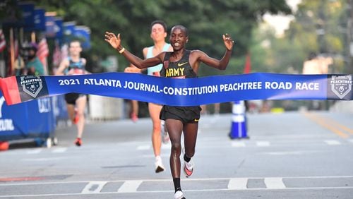 Sam Chelanga won the men’s elite division of the Atlanta Journal-Constitution Peachtree Road Race on Sunday morning as the AJC Peachtree Road Race returned in-person for the second day Sunday for the holiday tradition.  Hyosub Shin / Hyosub.shin@ajc.com