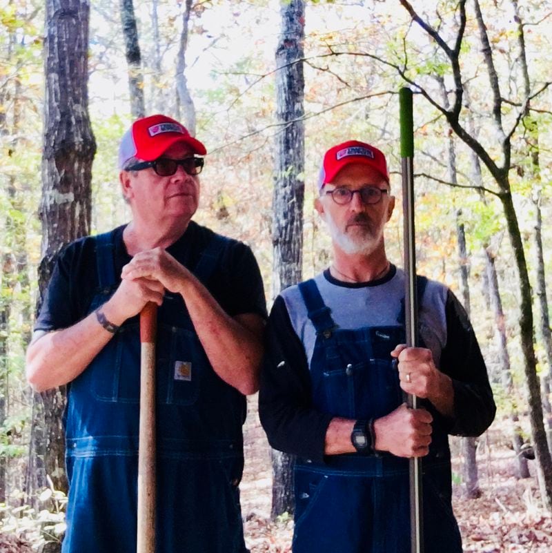 Sanctuary owner Grant Henry (left) and Richard Garner take a break while cutting hiking trails through the woods at Sanctuary. CONTRIBUTED