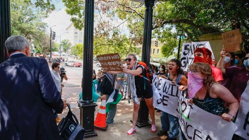 Pro-Palestinian protesters chant to a UGA staffer as he puts safety cones by the UGA  Arch as they rally at UGA campus in Athens following arrests on Monday, April 29, 2024.
(Miguel Martinez / AJC)