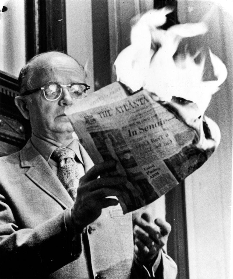 Atlanta, Ga., March 10, 1971 - Georgia Lt. Gov. Lester Maddox burns a copy of The Atlanta Constitution Wednesday in the state Senate. Maddox, who presides over the body, was incensed at an article which accused the Senate of being in shambles with a huge backlog of legislation. He said the newspaper did not have to 'guts, integrity, manhood or decency' to report the situation accurately. Maddox drew a standing ovation as he concluded a fiery speech and the burning of the newspaper. (Bill Wilson/AJC) 1971