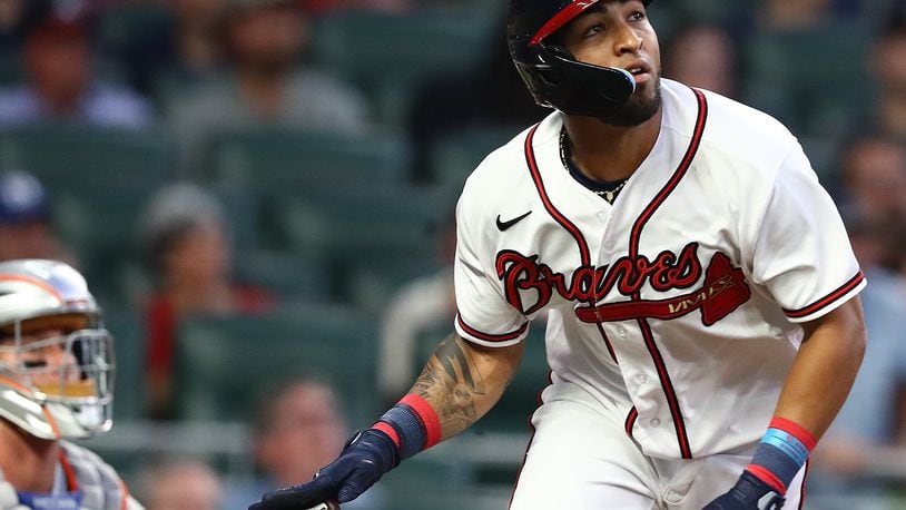 Braves outfielder Eddie Rosario watches his solo home run against the Mets on Monday night at Truist Park. Rosario exited Monday’s 13-1 walloping of the Mets in the sixth inning with left-hamstring tightness. (Curtis Compton / Curtis Compton@ajc.com)
