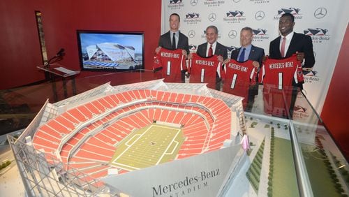 AUGUST 24, 2015: ATLANTA Falcons QB Matt Ryan, team owner Arthur Blank, President and CEO of MBUSA Steve Cannon and wide receiver Julio Jones pose with a model of the new Falcons stadium at a press conference announcing a deal for the naming rights for the New Falcons Stadium, which will formally be known as Mercedes-Benz Stadium. The agreement, which continues through 2042, includes official naming rights and other partnership benefits. The Mercedes-Benz brand will be prominent inside and outside the building, including on the roof; in plaza areas; on directional, on-field and tunnel signage; in club areas; in VIP parking and entrance areas; on the first-of-its-kind video halo board; and in additional areas. Financial terms of the agreement were not disclosed. Georgia Governor Nathan Deal and Atlanta Mayor Kasim Reed also attended the press conference.   KENT D. JOHNSON /KDJOHNSON@AJC.COM