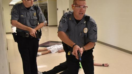 Officers in Villa Rica trained for a school shooting in 2015. Police won’t be the only ones legally armed in some Georgia school systems in coming years. Two school systems have approved arming teachers, and more are considering it. BRANT SANDERLIN