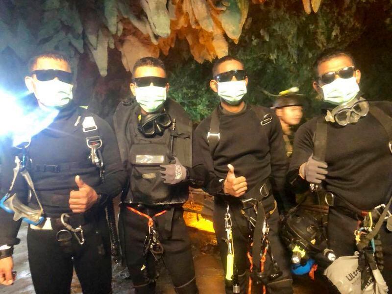 In this photo released by the Royal Thai Navy on Tuesday, July 10, 2018, the last four Thai Navy SEALs come out safely after completing the rescued mission inside a cave where 12 boys and their soccer coach have been trapped since June 23, in Mae Sai, Chiang Rai province, northern Thailand.
