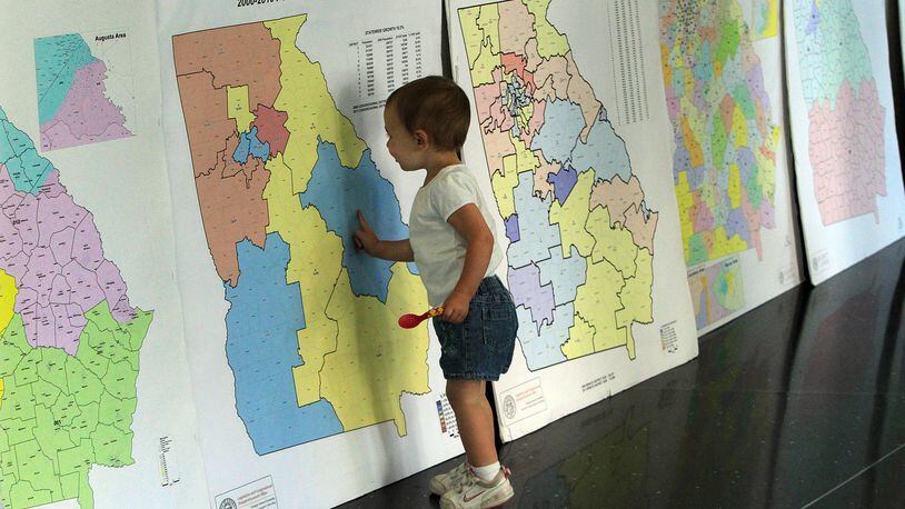 A child looks over redistricting maps during a 2011 public hearing. AJC FILE PHOTO