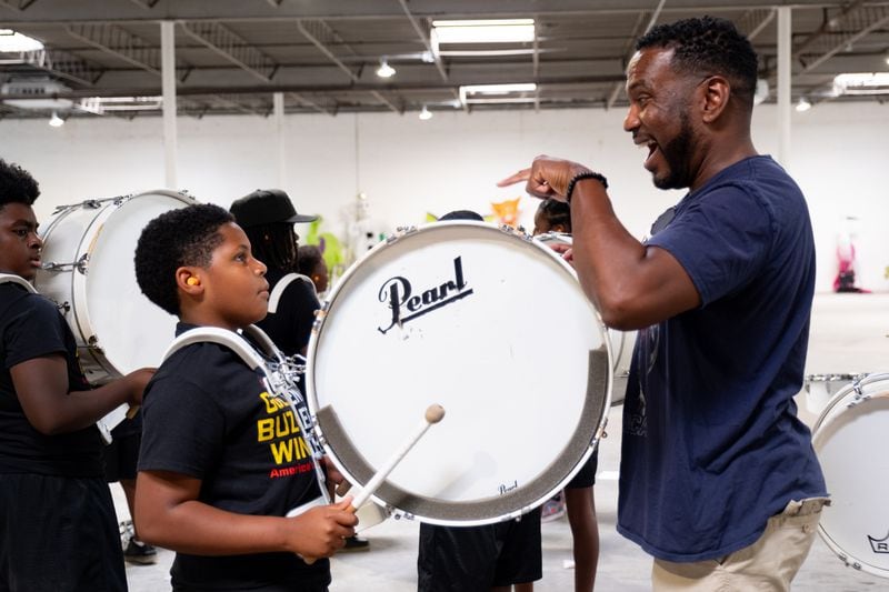 Guest clinician Timothy Greene reacts to 10-year-old Trayvonne Hamler's playing as the Lil' Rascalz drumline practices in Atlanta. (Ben Gray / Ben@BenGray.com)