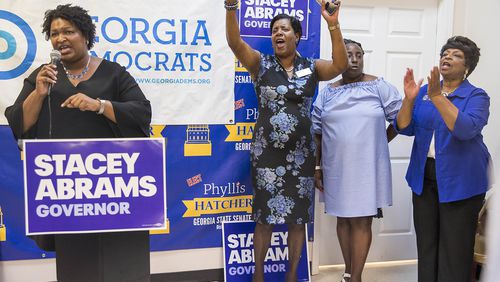 08/17/2018 -- Atlanta, Georgia -- While giving a speech, Georgia Gubernatorial Democratic candidate Stacey Abrams (left) is cheered on by Georgia State Senate District 17 candidate Phyllis Hatcher (clockwise) Georgia House Representative Sandra Scott (D) (second from right) and Georgia District 44 State Senator Gail Davenport (D) (right), during a Jobs Town Hall at the South Metro/Henry County Democratic field office in McDonough, Friday, August 17, 2018. (ALYSSA POINTER/ALYSSA.POINTER@AJC.COM)