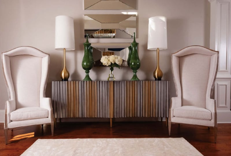 To lighten the dark foyer space, Atlanta sisters and design partners Barbara Elliot and Jennifer Ward-Woods painted the walls a soft gray and added a spectacular light fixture.