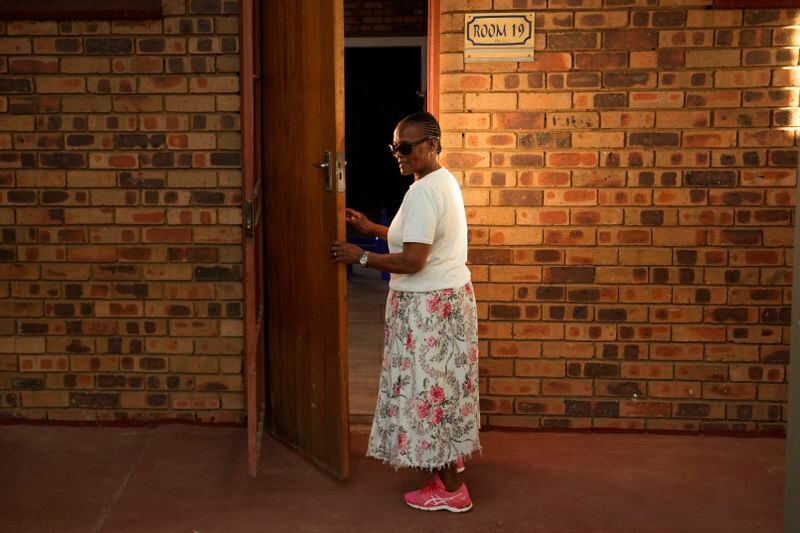 Lily Makhanya opens the classroom door at Thabisang Primary School where she voted for the first time 30 years ago, in Soweto, South Africa, Monday, April 22, 2024. In 1994 Makhanya joined thousands of South Africans who braved long queues to cast a vote in South Africa's first ever elections after years of white minority rule which denied Black South Africans the vote. (AP Photo/Themba Hadebe)