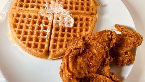 The signature dish at Johnny’s Chicken & Waffles can be ordered with a choice of protein, a plain or red velvet waffle and several sauces. Bob Townsend for The Atlanta Journal-Constitution