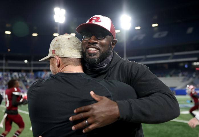 Warner Robins coach Marquis Westbrook, facing, celebrates with an assistant coach during their 62-28 win against against Cartersville in the Class 5A state high school football final at Center Parc Stadium Wednesday, December 30, 2020 in Atlanta. JASON GETZ FOR THE ATLANTA JOURNAL-CONSTITUTION