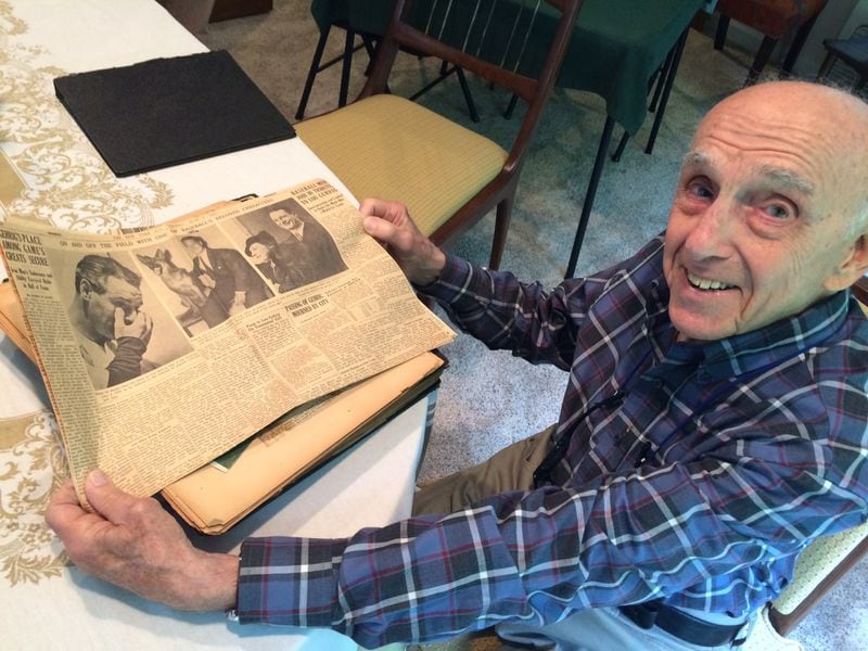 Doug Wexler with the baseball scrapbook he has tended to since the 1934 World Series. Here he displays newspaper accounts of the passing of Lou Gehrig. The Atlanta Braves, whom he followed for decades, have left him with a bad taste for how the business is now conducted. Photo by Bill Torpy