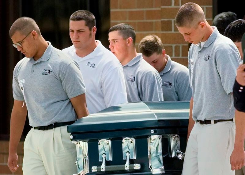 FILE - Pallbearers carry the casket of Columbine High School student, Matthew Kechter, out of St. Frances Cabrini Catholic Church in Littleton, Colo., April 27, 1999. Twenty-five years later, The Associated Press is republishing this story about the attack, the product of reporting from more than a dozen AP journalists who conducted interviews in the hours after it happened. The article first appeared on April 22, 1999. ( AP Photo/Eric Gay, File)