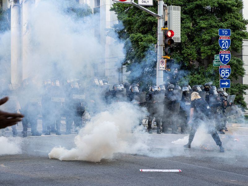 State law enforcement officers are seen behind a cloud of tear gas toward protesters fleeing the Capitol area on Tuesday, June 2, 2020. Contributed photo: John Ramspott