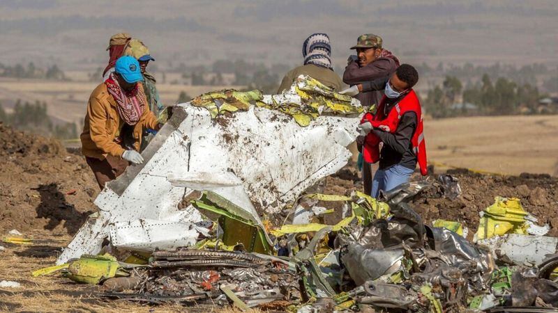 Rescuers work at the scene of an Ethiopian Airlines flight crash near Bishoftu, or Debre Zeit, south of Addis Ababa, Ethiopia, Monday, March 11, 2019. A spokesman says Ethiopian Airlines has grounded all its Boeing 737 Max 8 aircraft as a safety precaution, following the crash of one of its planes in which 157 people were killed.  