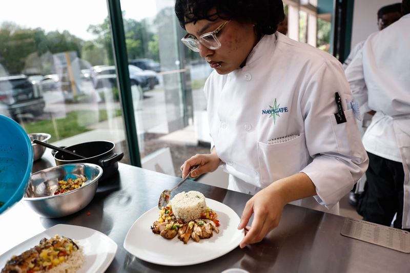 Cecilia Lopez Ramirez plates a meal during a guided cooking lesson with the Navigate Foundation on Tuesday, May 7, 2024. Through the program, students from Atlanta area schools get hands-on training in the field and culinary internships. (Natrice Miller/ AJC)