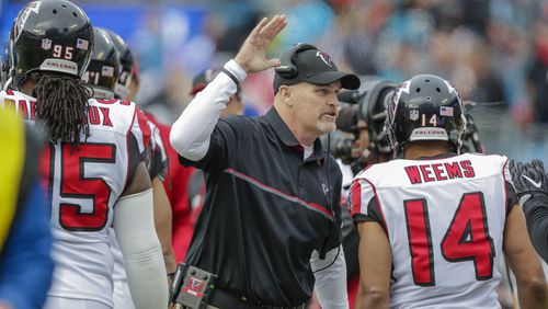 Falcons head coach Dan Quinn is positively delighted with his team's performance Saturday in Charlotte, one that eventually led to a NFC South title. (AP photo/Bob Leverone)