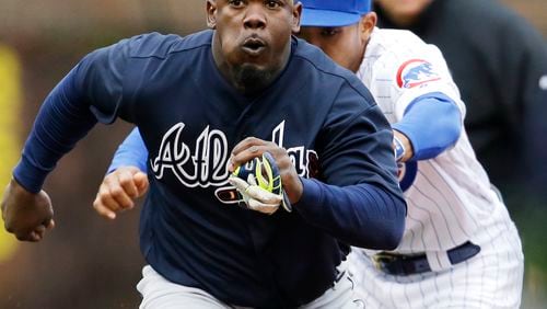 Atlanta Braves' Adonis Garcia is tagged out by Chicago Cubs shortstop Addison Russell during the sixth inning of a baseball game, Sunday, May 1, 2016, in Chicago. (AP Photo/Nam Y. Huh)