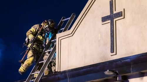 DeKalb County firefighters battle a blaze at the Celestial Citizens Global church on Richard Road on Friday, April 19, 2024. No one was injured, and the cause remains under investigation. The blaze damaged one-third of the structure, and the rest of the property sustained smoke and water damage, authorities said. (John Spink/AJC)