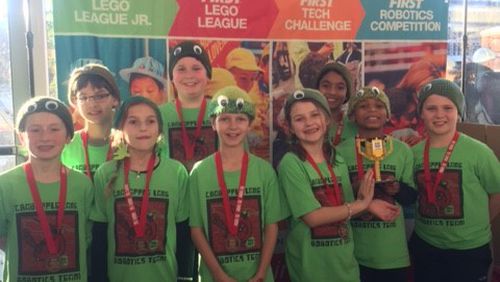 The Cardinal Crushers display the trophy they won for best presentation at the 2017 FIRST LEGO League State Championship at Georgia Tech.