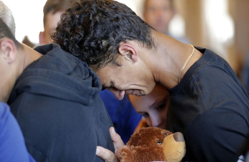 Austin Burden, 17, cries on the shoulder of a friend after a vigil at the Parkland Baptist Church, for the victims of the Wednesday shooting at Marjory Stoneman Douglas High School, in Parkland, Fla. (AP Photo/Gerald Herbert)