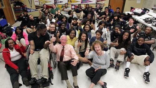 Thumbs up: Tom and Kathy Kelly with the Dreamers at Greene County High School in March 2012. In 2000 the couple promised a class of kindergartners they would send them to college if the children graduated from high school. Now many of those same kids are graduating from college. (AJC file / Curtis Compton)