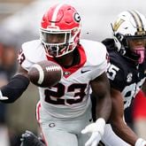 Georgia defensive back Tykee Smith (23) makes an interception against Vanderbilt wide receiver Junior Sherrill, right, in the first half of an NCAA college football game Saturday, Oct. 14, 2023, in Nashville, Tenn. (AP Photo/George Walker IV)