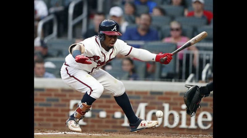 Ozzie Albies reacts after being hit on the foot by a pitch from Cincinnati’s Matt Harvey in the fourth inning Tuesday. (AP Photo/John Bazemore)