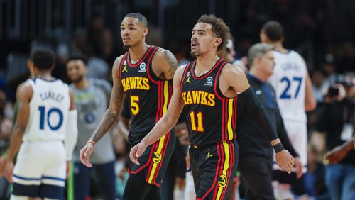 Hawks guards Dejounte Murray (5) and Trae Young (11) walk back to the bench during their loss against the Minnesota Timberwolves at State Farm Arena, Monday, March 13, 2023, in Atlanta. The Timberwolves won 136-115. Jason Getz / Jason.Getz@ajc.com)
