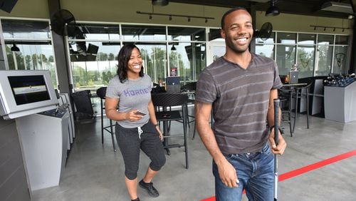 Ali Kirkpatrick and his girlfriend Shavonne Verdree share a smile as they play and eat at TopGolf Atlanta Midtown.